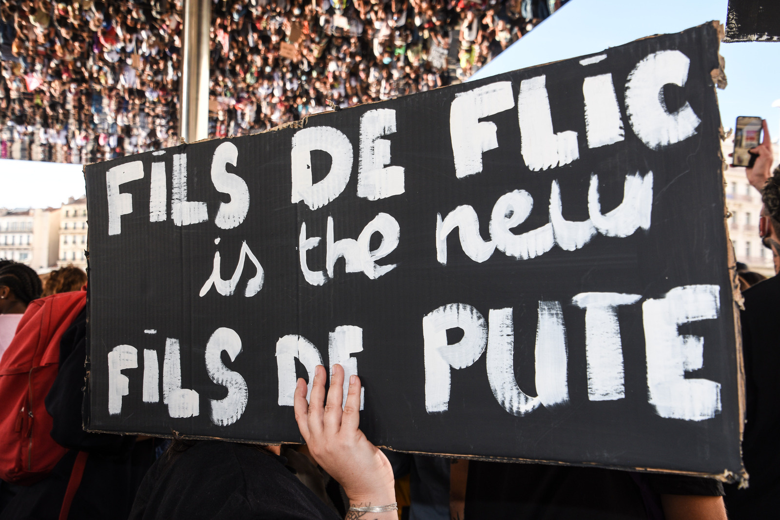 (EDITORS NOTE: Image contains profanity) A protester holds a placard during the demonstration.
Demonstration against racism and police violence in echo to the murder of George Floyd and Adama Traore by a police officer in the United States.