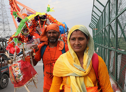 A Lord Shiva devotee seen carrying sacred Ganga Jal (Holy water) collected from Haridwar as he walks towards their home town temple near Inter-State Bus Terminal (ISBT) during the ongoing Kanwar Yatra. Devotees of Lord Shiva perform jalabhishek to fulfill their wishes on the occasion of the Hindu festival Maha Shivaratri.