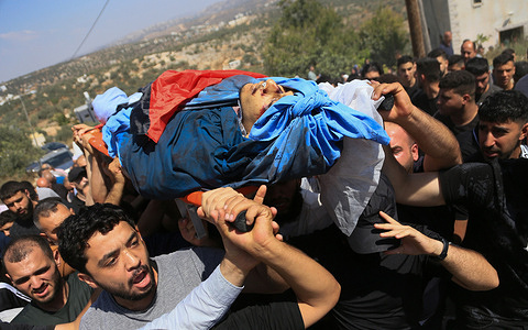 IMAGES DEPICT DEATH: Palestinian mourners seen carrying the body of Omar al-Toubasi who was killed during clashes with Israeli soldiers and Jewish settlers in the village of Hajja. Omar was killed during an attack by Jewish settlers on his home, which also left four members of his family seriously wounded. Omar was a medical student at An-Najah National University.