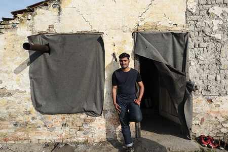 Standing at the entrance to a room he shares with five others a migrant from Pakistan relaxes in the afternoon sun.Horgos is a village located in Kanjiza municipality, in the North Banat District of Serbia, less than 10km from the Serbian Ð Hungarian border. The Balkan route was officially closed over a year ago with Croatia and Hungary increasing border security which has led to migrants and refugees becoming stuck in Serbia. While the borders around Serbia have tightened there are still attempted border crossings every night. Migrants from Pakistan prefer to illegally enter the EU rather than risk waiting for their asylum applications to be rejected and then forcibly deported back to Pakistan.