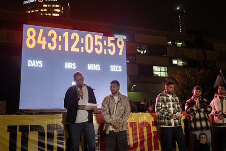 Former hostage Haim Yosef Ohana and Michel, the father of the deceased hostage Guy Iluz, speak at a rally in Hostages Square marking the stopping of the clock counting the hostages in Gaza. After 843 days, the clock counting the painful wait for Israel’s hostages has finally stopped, the clock was one of the most powerful symbols at Tel Aviv’s Hostages Square counting every minute, hour, and day since 251 Israelis were abducted by Hamas on October 7, 2023. a day after the body of the last Israeli hostage, Ran Gvili, was returned to Israel, the clock counting has finally stopped. Many Israelis arrived at Hostages Square for a rally to witness the stop of the clock. Former hostages and families of hostages also attended, moved by the fact that for the first time in many years there are no longer any Israeli hostages in Gaza.