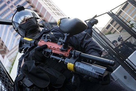 A DHS officer seen with a less-lethal weapon as tensions rise against protesters. Protesters clash with DHS officers at the Metropolitan Detention Center (MDC) in Los Angeles, during the nationwide "Mayday" protests occurring across the United States.