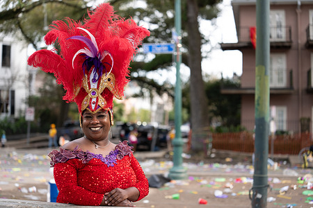A woman poses for a photograph along St. Charles Avenue during Mardi Gras celebrations Mardi Gras in New Orleans peaked on Feb. 17, 2026, as the Zulu and Rex krewes led parades with large floats and marching bands along St. Charles Avenue. Masked riders tossed signature “throws,” including Zulu’s hand-painted coconuts and colorful beads, to cheering crowds. The celebrations ended at midnight, marking the start of the Lenten season.