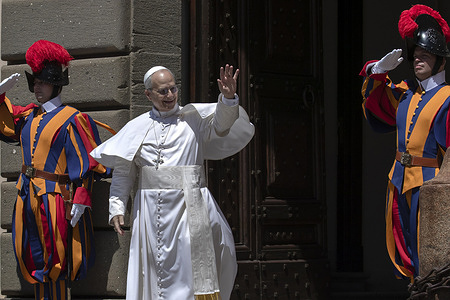 Pope Leo XIV waves at the crowd at the end of the Angelus prayer from the Apostolic Palace of Castel Gandolfo, where the pontiff is spending his summer vacation.