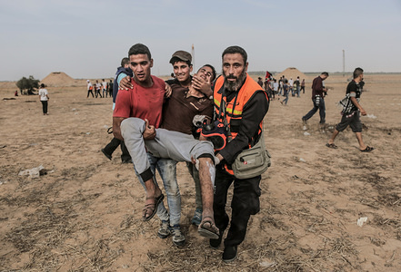Medical workers carry a wounded person during the clashes.
Palestinians clashed with Israeli forces during a major demonstration on the Gaza border demanding for the right to return to their homes at the border fence between Israel and Gaza in the southern Gaza Strip.