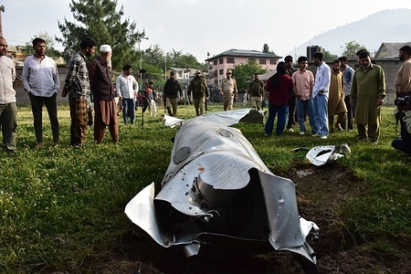 Residents look at a wreckage of an unknown aircraft in Wuyan area of Pampore, about 15kms from Srinagar. India launched "Operation Sindoor", striking nine sites in Pakistan. Pakistan reports missile attacks on six locations, killing at least eight and injuring 35, calling it an “act of war.” Two unidentified jets crashed in Jammu and Kashmir shortly after the strikes. Pakistan says the death toll has reached 26 from Indian attacks, with 10 more killed in Pakistani shelling along the border.