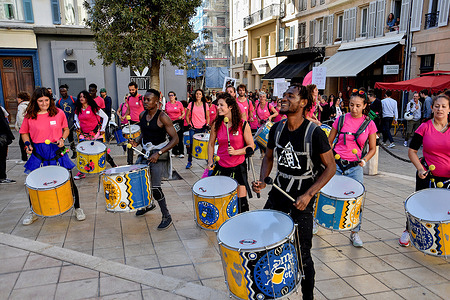 Participants dressed in pink t-shirts play percussion in the street during the demonstration. On the occasion of the 29th edition of Pink October, which takes place from October 1 to 31, 2022, people dressed in pink t-shirts demonstrated in Marseille to raise public awareness of early detection of breast cancer.