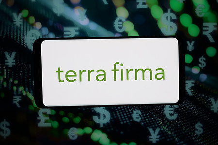 In this photo illustration, the logo of company Terra Firma Capital Partners Limited is displayed on a smartphone in front of abstract background on computer screen.