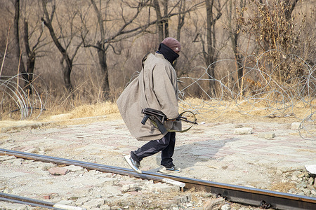 Indian security personnel acting as a militant walk during a mock drill at a railway station ahead of Republic Day in Srinagar. Jammu and Kashmir Police, the Central Reserve Police Force and other security agencies carried out the exercise to test coordination and enhance preparedness against potential militant threats and emergency situations as security is tightened across the Himalayan region, including intensified vehicle checks, increased patrols and expanded surveillance using drones and high resolution CCTV cameras, ahead of India’s 77th Republic Day on January 26, which marks the adoption of India’s constitution in 1950.