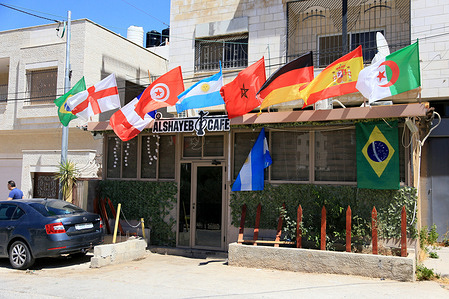 A Palestinian decorations store in Nablus, West Bank, is displaying the flags of the countries participating in the World Cup. The FIFA World Cup 2026 is being held for the first time in three countries: the United States, Mexico, and Canada. Eight Arab countries are participating. A total of 48 national teams from around the world are participating in the World Cup.