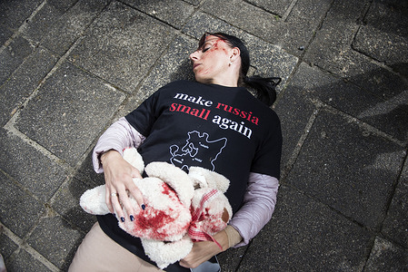 Ukrainian protesters covered with fake blood lay on the pavement as a symbol for victims of the Russian invasion on Ukraine while the Russian ambassador puts flowers at the monument. On "Victory Day" Russia's Ambassador to Poland, Sergey Andreev and his delegation laid a wreath on a monument at the cemetery to Red Army soldiers who died during World War II. During the ceremony Ukrainian activists tried to disturb the event. May 9th known as "Victory Day" in Russia is a holiday commemorating the Soviet victory over Nazi Germany in 1945.