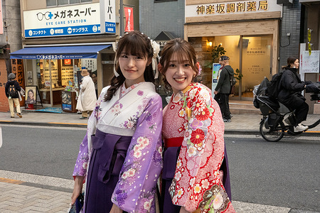 Two women wearing traditional kimono pose for a photograph on a street in the Kagurazaka district of Tokyo Kagurazaka is a historic Tokyo district known for its narrow stone alleys, traditional ryotei restaurants, and lingering geisha culture. Blending old-world charm with a subtle French influence, it offers a quieter, more refined atmosphere compared to the city’s busier neighborhoods.