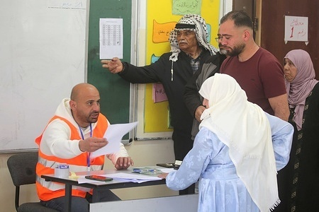 Palestinians register to vote at a polling station during the municipal elections in the town of Beit Furik, east of Nablus in the West Bank. Palestinians in the West Bank and central Gaza Strip began voting in municipal and local council elections in the West Bank.