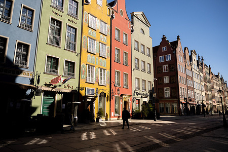 A man walks across an empty main Street in the old town of Gdansk.By the decision of the government, from March 20 to April 9, new restrictions will be introduced related to the coronavirus pandemic in Poland. This means that the new restrictions will apply during Easter. The daily average of infections in Poland in the last seven days amounted to over 22,200 cases.