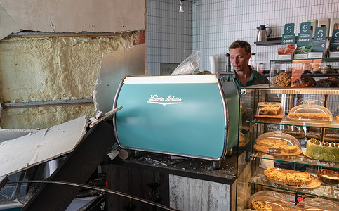 A barista is seen operating an espresso machine inside a damaged cafe in Kyiv, Ukraine, brewing coffee for customers following a massive Russian missile strike destroying civilian infrastructure. Russia launched a massive combined strike on Kyiv and the Kyiv region, utilizing ballistic and cruise missiles, as well as attack drones. Explosions were reported across all districts of Kyiv. Residential buildings, schools, and civilian infrastructure sustained damage. The air raid alert lasted for several hours. The most severe destruction was recorded in the Shevchenkivskyi, Podilskyi, and Dniprovskyi districts. Currently, two fatalities have been confirmed, and 44 people have been injured in Kyiv. Additional casualties have also been reported across the Kyiv region. Medical teams and emergency responders continue operations at the scene. According to preliminary data, Russia deployed attack UAVs and several types of missiles, including ballistic ones. Both Russian and Ukrainian monitoring channels also reported the use of the "Oreshnik" missile in the city of Bila Tserkva, Kyiv region.