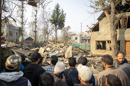 People inspect as rubble is seen at the demolished family home of Dr Umar Nabi in Koil village of Pulwama district, south of Srinagar. Authorities blew up the family home of Dr Umar Nabi in Koil village of Pulwama after naming him a prime suspect in the Delhi car explosion that killed 13 people and injured dozens. Indian officials are treating the blast as a terrorist incident, and Prime Minister Narendra Modi said the conspirators “will not be spared”. Security forces have launched raids across Kashmir, searching hundreds of homes linked to banned organisations amid a high-alert situation.