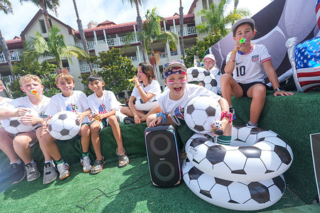 Children sit on a soccer theme modified truck during the parade. Spectators line Orange Avenue as participants march through the annual Independence Day Parade in Coronado on July 4, 2026. The parade, featuring marching bands, military units, community organizations, and decorated vehicles, was part of the city's Independence Day celebrations marking America's 250th birthday and drew thousands of residents and visitors to the coastal community of San Diego area.