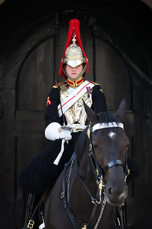 A member of the Household Cavalry guards the entrance to Horse Guards Arch during a mini heatwave in London. Warm weather conditions are forecasted over the next few days with the temperature reaching 25C in many parts of the UK.