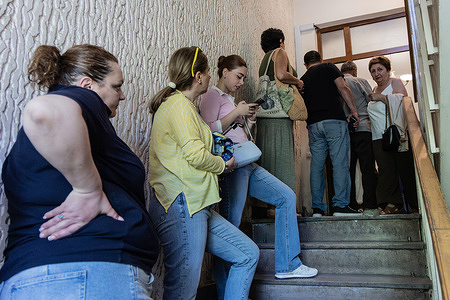 Voters stand in line at a polling station in central Yerevan during Armenia’s parliamentary elections.