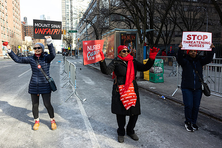 Protesters hold placards expressing their opinion during the demonstration. Nurses rally on the picket line outside of Mount Sinai West on day 11 of the NYSNA supported strike. The union is demanding a contract that includes safe staffing, protection from workplace violence and pay increases.