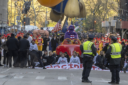 Macy's Thanksgiving Day Parade was temporarily paused when a handful of pro-Palestinian protesters jumped the barricades and ran into the street along the parade route on Sixth Avenue in New York City.