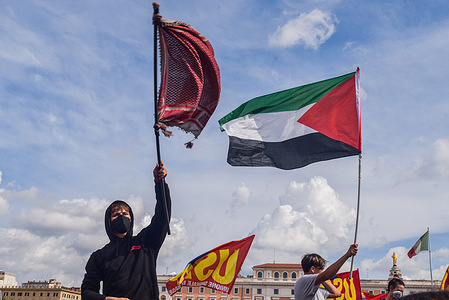 Activists wave flags during the protest supporting Palestine and the Global Sumud Flotilla.