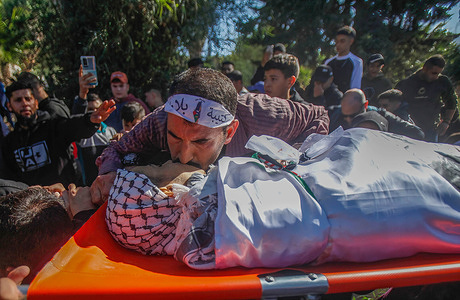 A relative kisses the body during the funeral of Palestinian Amjad Shehadeh, 16 years old who was shot dead by the Israeli army as Jewish settlers stormed Joseph's tomb.