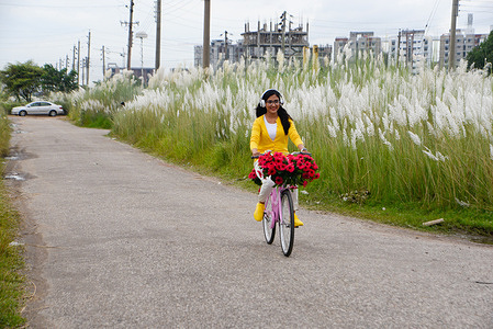 A girl rides a bicycle on the road along a catkins field in Dia Bari.
Dia Bari is the most popular attractive destination for tourists in Dhaka. It is a very nice green place to pass leisure time. There is a huge open place in Dia Bari where many people go with their families, friends, lovers for some fun and refreshment.