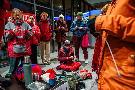 Women wearing red clothes are seen knitting during the demonstration. The feminist group DolleMina organized a protest that consisted of knitting and crocheting against sexual and gender-based violence at the train station of Nijmegen. Stitches Against Violence is a Vienna-based initiative by Stitch Sip Knit, Footprint Vienna, and Stop Wien. The goal is to raise awareness and foster a culture of respect and safety.