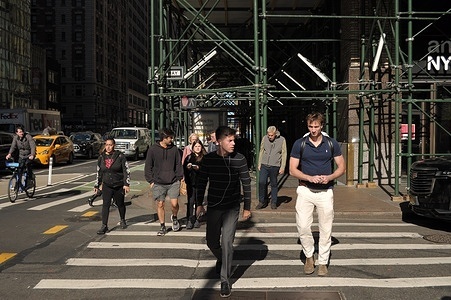 People walk down the street in Manhattan, New York City.