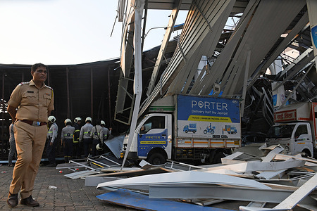 View of damaged vehicles at a petrol station after an advertising hoarding fell on them due to strong wind and rain in Mumbai. 14 people died and 70 were injured after getting trapped below the advertising hoarding that fell on to the Gas station at the Cheddanagar Junction in Ghatkopar, where many had come with their vehicles to fill gas and petrol.