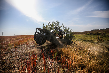 A volunteer team tests an Attack buggy in the field. An Attack Buggy is a fast, maneuverable vehicle that's tough to hit and can't be destroyed easily by anti-tank missiles. It's great for quick retreats and is used to carry soldiers, ammo, and rescue injured fighters from the frontlines. Ukrainian volunteers manufacture essential equipment like attack buggies, sleeping bags, and body armor specifically for the Ukrainian military, aiding them in their counter-offensive against Russian forces.