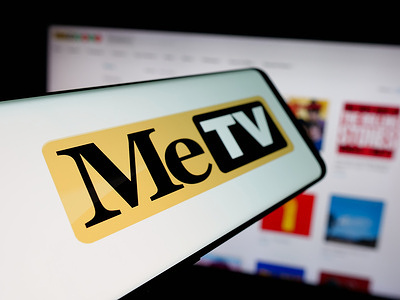 In this photo illustration, a smartphone with the logo of US broadcast television network MeTV is seen on screen in front of website.