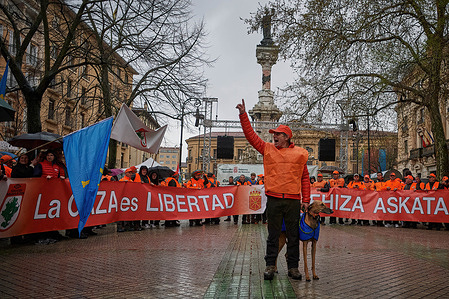 Thousands of protesters hold a banner and flags during a demonstration in favor of hunting and in rejection of the new animal protection law issued by the Government of Pedro Sánchez in Spain. Demonstration was held against the Animal Protection Law through the streets of Pamplona, Navarra.