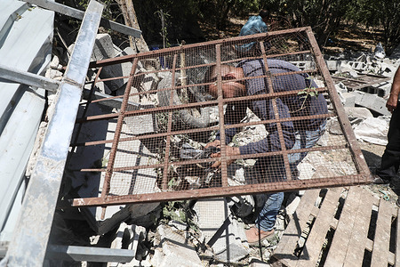 A Palestinian rescues his pigeon from under the rubble of a destroyed building in the village of Burqa, north of Nablus, near the Jewish settlement of Homesh. The Israeli army forces demolished the building on the grounds that it was built in Area C, which is under Israeli government control according to the Oslo Accords.
