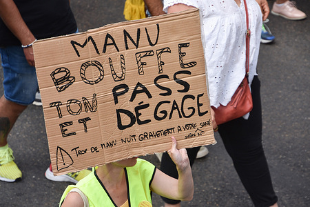 A protester holds a placard during the demonstration against the health pass in Marseille.
French President Emmanuel Macron announced among new anti-Covid 19 measures a "health pass" which will be necessary to be frequenting café terraces, restaurants, cinemas, theatres and other culture and leisure activities to help contain the spread of the Covid-19 virus.