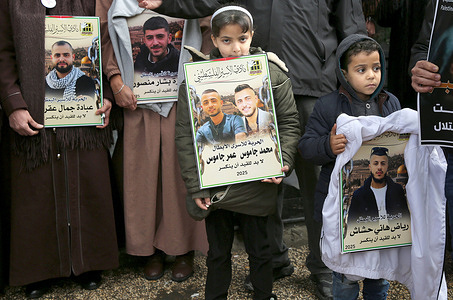 Palestinian children seen holding up photos of their relatives detained in Israeli prisons during a demonstration in downtown Nablus in the West Bank, demanding their release. According to the Palestinian Prisoners Club, approximately 700 prisoners from Nablus are currently held in Israeli prisons.