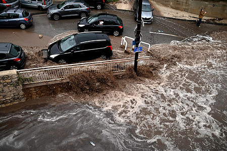 Vehicles seen parked on Chemin du Marinier during flooding on Chemin de la Nerthe in the L'Estaque district of Marseille. Heavy torrential rains hit the Estaque district of Marseille on September 21, 2025. Torrents of mud rushed down the streets, sweeping vehicles away.
