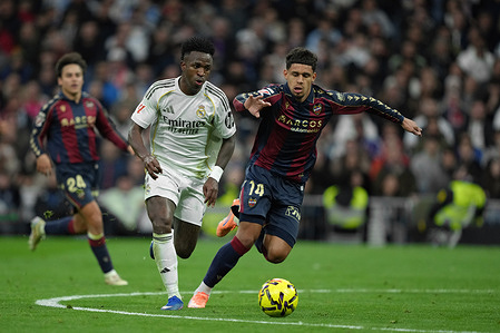 Vinícius Júnior of Real Madrid CF is seen in action under the pressure from Ugo Raghouber of Levante UD during the LaLiga EA Sports match between Real Madrid CF and Levante UD at the Santiago Bernabéu. Final Score: Real Madrid CF 2 - 0 Levante UD