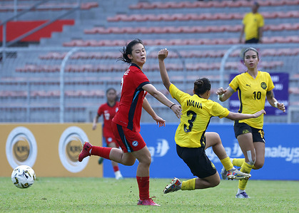 Danelle Tan of Singapore (L) and Eusvewana Kadius (C), Steffi Sarge Kaur (R) of Malaysia are seen in action during the AFF Women's Cup 2026 match between Malaysia and Singapore at Kuala Lumpur Football Stadium, Cheras. Final score; Singapore 3 : 1 Malaysia.