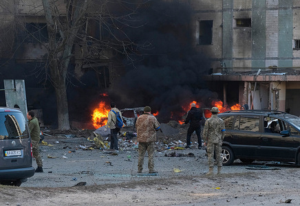 Soldiers and police examine the aftermath of a missile landing near a residential building after being shot out of the sky in the Bilychi neighborhood in Kyiv. A missile was shot out of the sky and landed near a residential building in the Bilychi neighborhood in Kyiv, Ukraine causing damage to the buildings and injuries to residents.