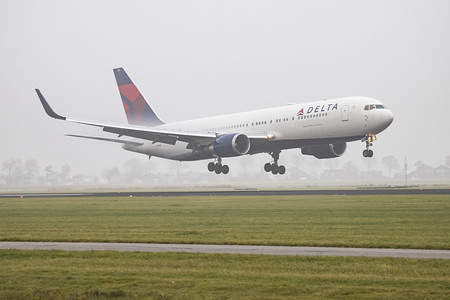 Delta Air Lines Boeing 767-300 seen landing at Amsterdam Schiphol Airport in mist. The aircraft has the registration N172DZ.