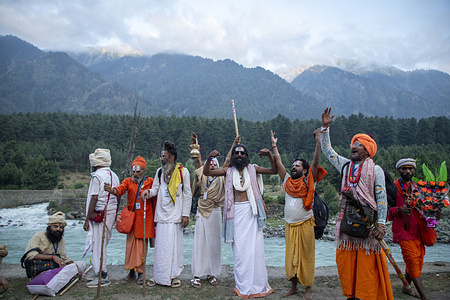 Hindu pilgrims chant religious slogans during the annual pilgrimage to the sacred Amarnath Caves, one of Hinduism’s most revered shrines. Thousands of devotees braving subzero temperatures begin the steep trek over glaciers and narrow paths above deep gorges to reach the cave which houses a naturally formed ice stalagmite worshipped as a symbol of the Hindu god Shiva. Pahalgam, the key and traditional route as well as the main base camp for the pilgrimage, was the site of a deadly militant attack on April 22 that killed 26 Hindu tourists and triggered the worst escalation between nuclear-armed rivals India and Pakistan in decades. More than 300,000 devotees are expected to take part in this year's two-month pilgrimage which is taking place under heightened security with Indian paramilitary forces, police, sharpshooters and drones deployed along the route to prevent further violence in the disputed Himalayan region where militants have been fighting Indian rule since 1989.