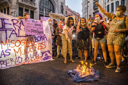 Demonstrators are seen burning a burqa during the demonstration.Around a hundred women have participated in a feminist demonstration in front of the United Nations headquarters in Barcelona to demand an urgent international response to protect Afghan women and girls.