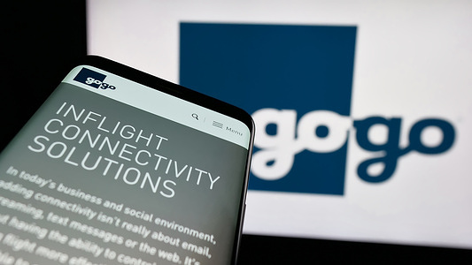 In this photo illustration, a mobile phone with the website of US company Gogo Business Aviation is seen on screen in front of logo.