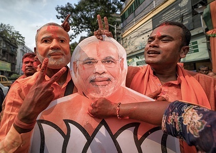 A Bharatiya Janata Party supporter seen applying colour on Narendra Modi's cut-out during the celebrations in front of the Party Head quarter in Kolkata after making massive Win in West Bengal & India election.Bharatiya Janata Party (BJP) wins election in Kolkata, India.