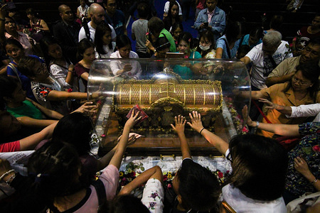 Catholic devotees seen touching the Shrine of Saint Therese of the Child Jesus in New Port City in Pasay, Metro Manila, for the veneration of the holy relic of Saint Therese of Lisieux. The reliquary containing the bones of Saint Therese has been on a nation wide tour and is on its last few days in Manila before heading back to France.