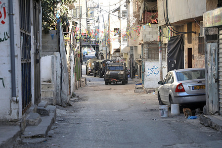 Israeli military vehicles patrol the street during a raid in Balata refugee camp. Israeli forces raided the home of a young Palestinian man and arrested him in Balata refugee camp.