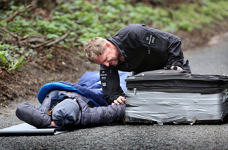 A specialist police officer inspects the suitcase lock-on during the demonstration. UAV Engines are owned by the Israeli defence company Elbit Systems and they provide engines and other parts for drones. Protesters claim that these drones are currently being used by Israelis against Palestinian civilians in Gaza and the West Bank and parts for the drone responsible for killing seven aid workers recently were made at UAV Engines. The protesters also demand arms companies stop selling arms to Israel and contributing to the Gaza genocide.