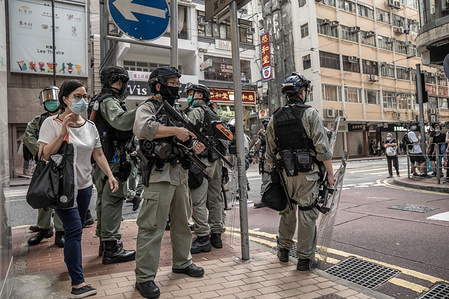 Riot police stand guard with their weapons at Causeway Bay district as demonstrators are anticipated to gather in the area to protest against the National Security Bill.
The Hong Kong Police has made over 360 arrests as thousands of pro democracy demonstrators took to the streets of Hong Kong to protest against the proposed Nation Security Bill by the Beijing central government.